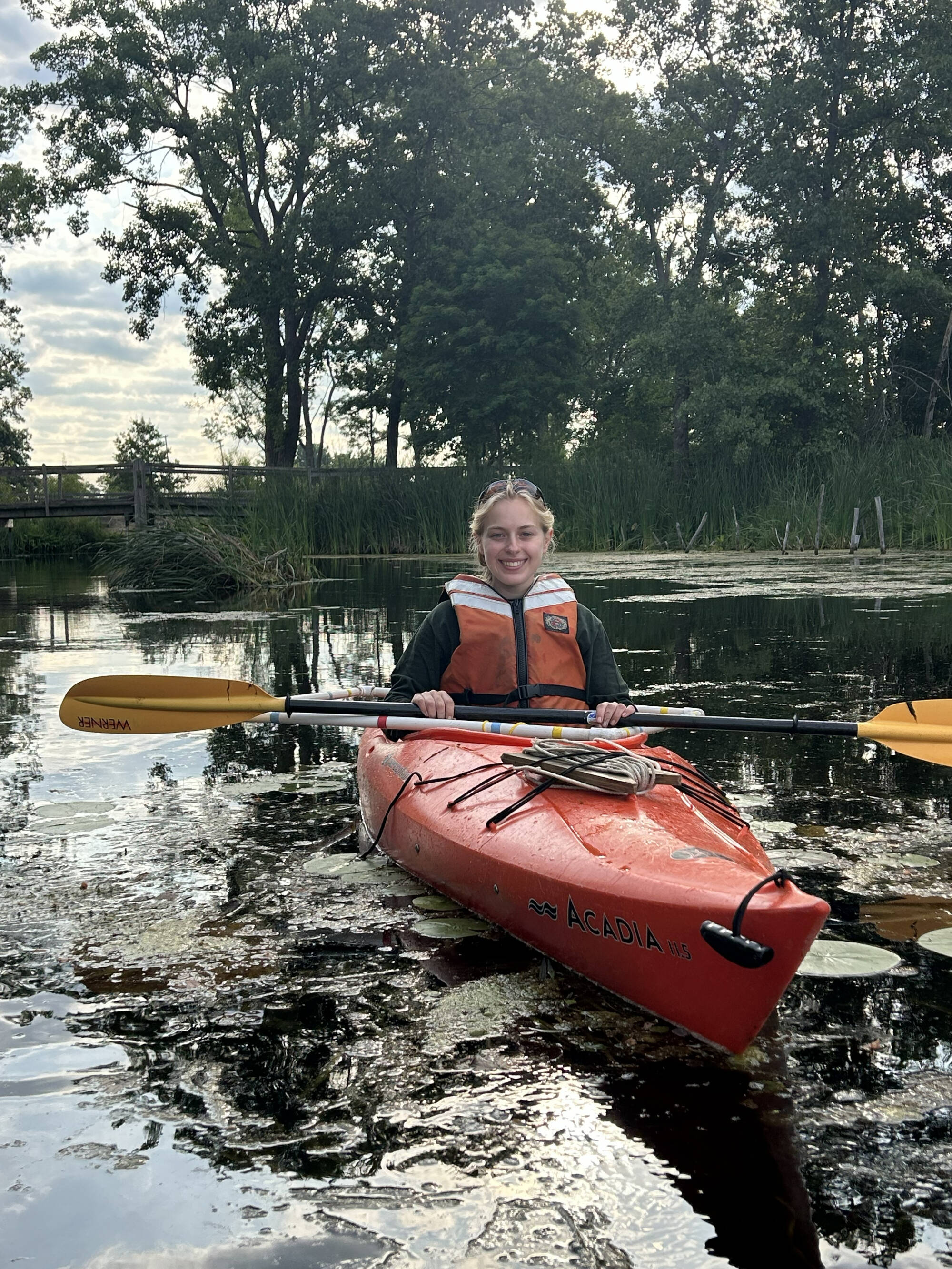 A research assistant evaluates fish habitat near the Muskegon Lake Nature Preserve